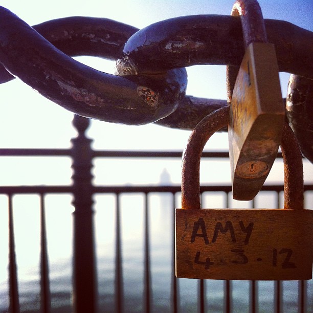 There are varied explanations for the origin of love padlocks. In Europe, love padlocks started appearing in the early 2000s. The reasons love padlocks started to appear vary between locations, and in many instances are unsourced. 
An attribution for the bridge Most Ljubavi (lit. the Bridge of Love—now named after the love padlocks) in Serbia exists, where they can be traced to even before World War II. A local schoolmistress named Nada, who was from Vrnjačka Banja, fell in love with a Serbian officer named Relja. After they committed to each other Relja went to war in Greece where he fell in love with a local woman from Corfu. As a consequence, Relja and Nada broke off their engagement. Nada never recovered from that devastating blow, and after some time she died as a result of her unfortunate love. As young girls from Vrnjačka Banja wanted to protect their own loves, they started writing down their names, together with the names of their loved ones, on padlocks and affixing them to the railings of the bridge where Nada and Relja used to meet.